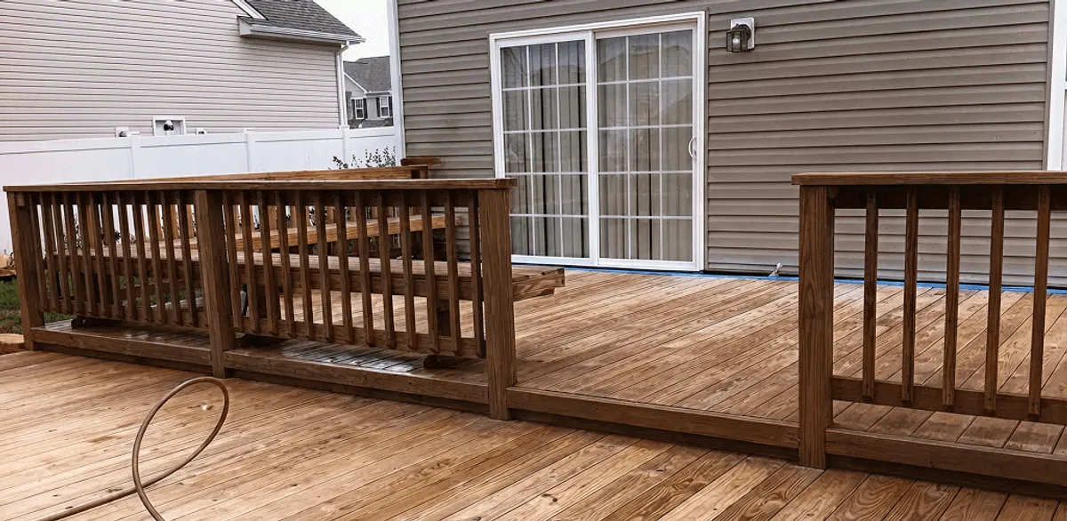 Deck sealing service protecting a backyard wood deck and railings in New Orleans, LA