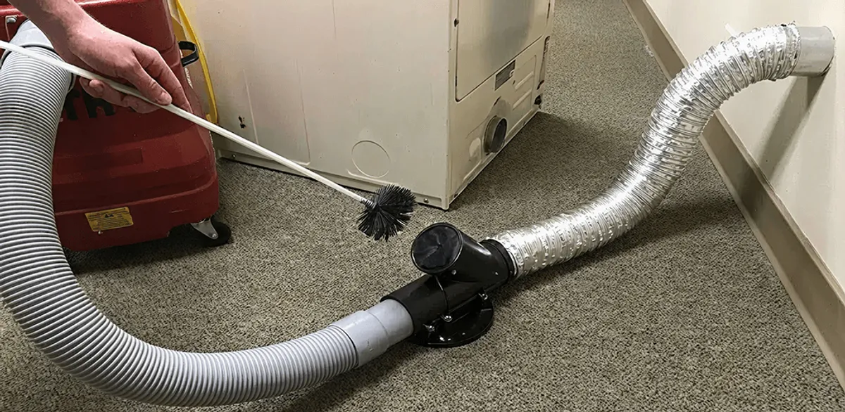 Dryer vent cleaning service removing lint from a dryer duct connection in New Orleans, LA