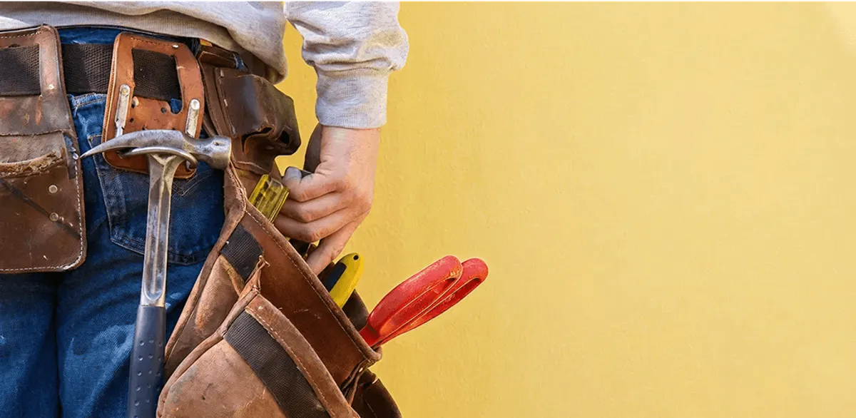 Handyman with tool belt ready for home repairs and maintenance in New Orleans, LA