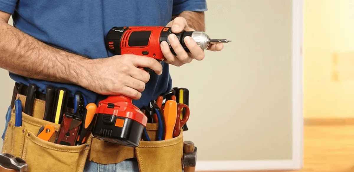 Handyman holding a power drill for home repairs and installations in New Orleans, LA